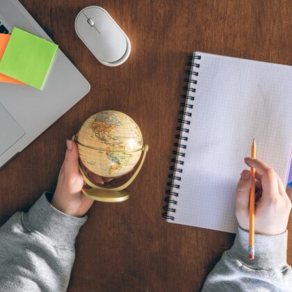 Globe, laptop and notepad — planning to work abroad