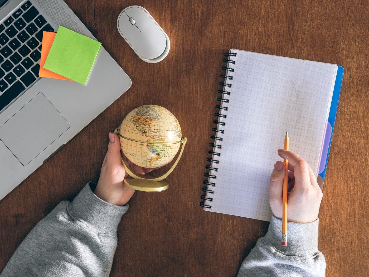 Globe, laptop and notepad — planning to work abroad