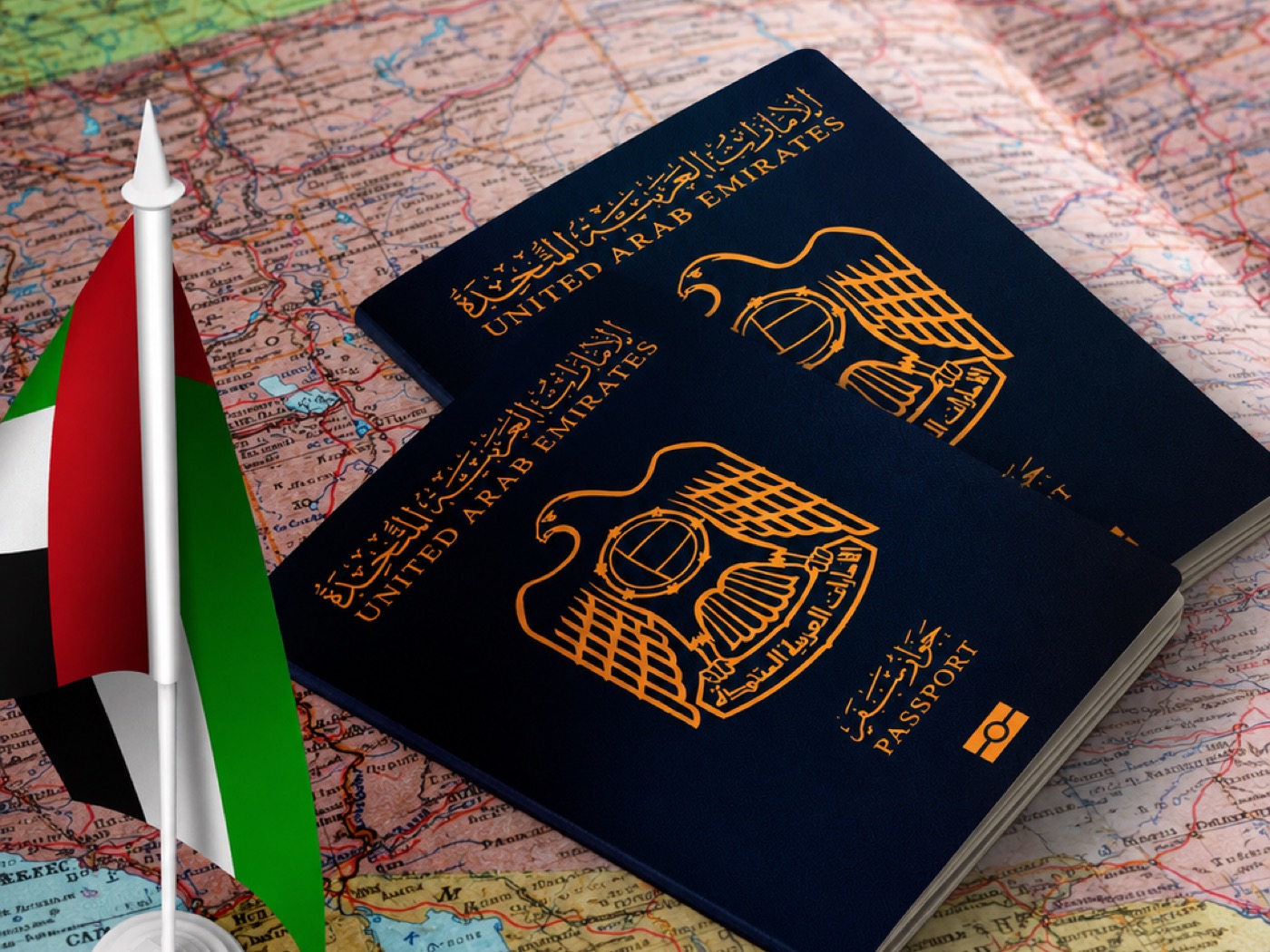 UAE passports and flag on a world map